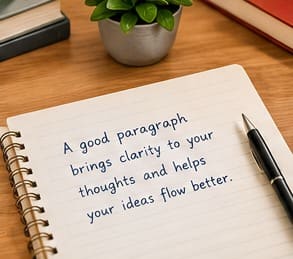 paragraph writing: Notebook and pen beside a laptop