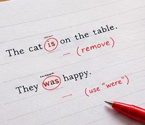 Notebook and pen beside a laptop
